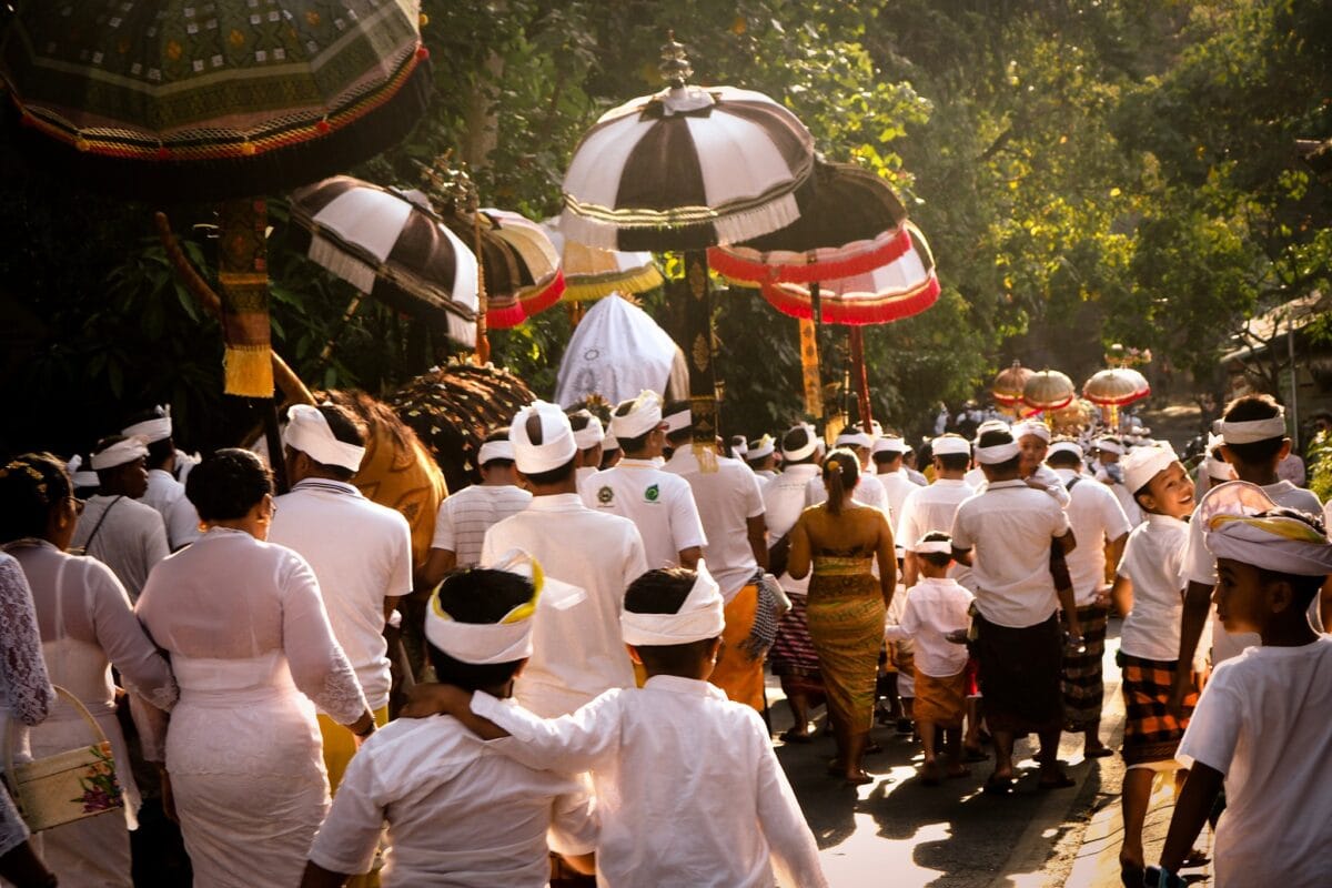 A colorful sarong and sash displayed against a temple backdrop in Bali, symbolizing spiritual harmony and cultural tradition.