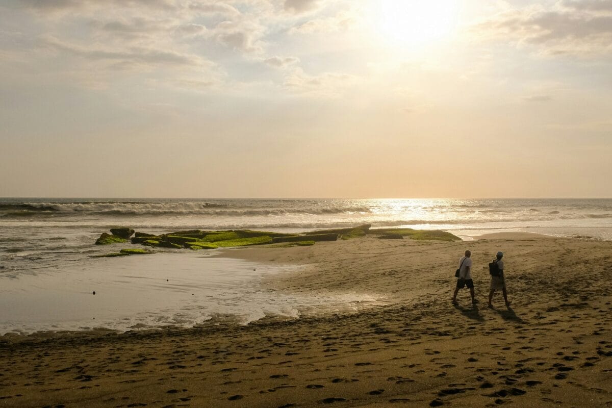 Surfer at sunset on Pererenan Beach in Bali.